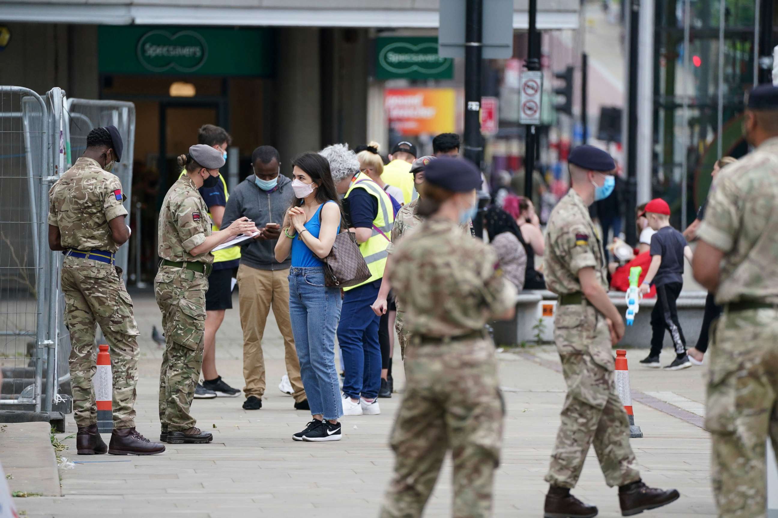 PHOTO: Members of the Armed Forces speak to people, outside a mobile COVID-19 vaccination center outside Bolton Town Hall, in Bolton, England, June 9, 2021, where case numbers of the Delta variant first identified in India have been relatively high.