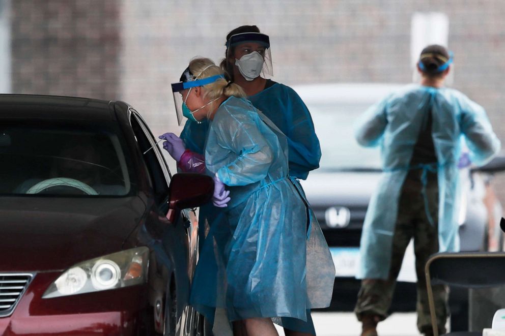 PHOTO: A health worker performs a COVID-19 test at a Test Iowa site at Waukee South Middle School, July 14, 2020, in Waukee, Iowa.