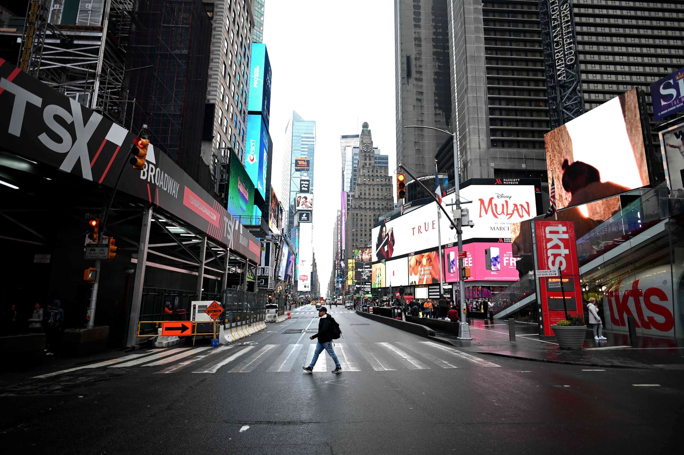 PHOTO: A tourist crosses the 7th Avenue at Times Square on March 13, 2020, in New York.