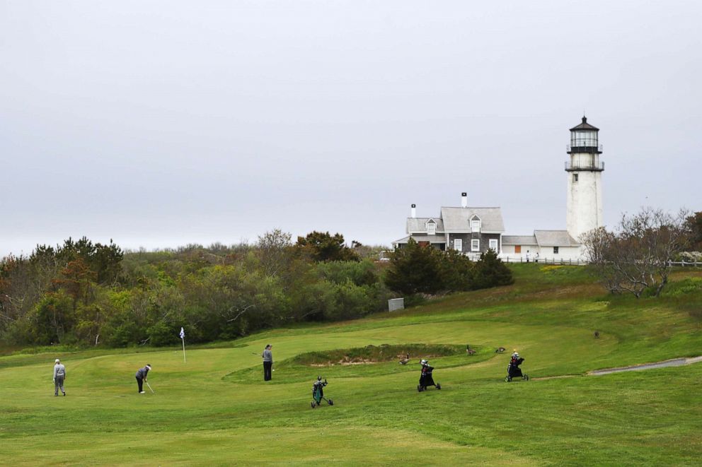 PHOTO: People play a round of golf in front of the Highland Lighthouse on May 25, 2020, in North Truro, Mass.