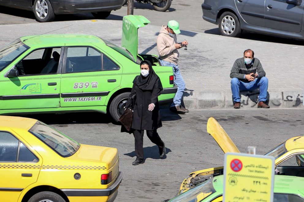PHOTO: Iranian taxi drivers wait for costumers while wearing protective masks in Tehran on March 10, 2020 amid the spread of coronavirus in the country. 