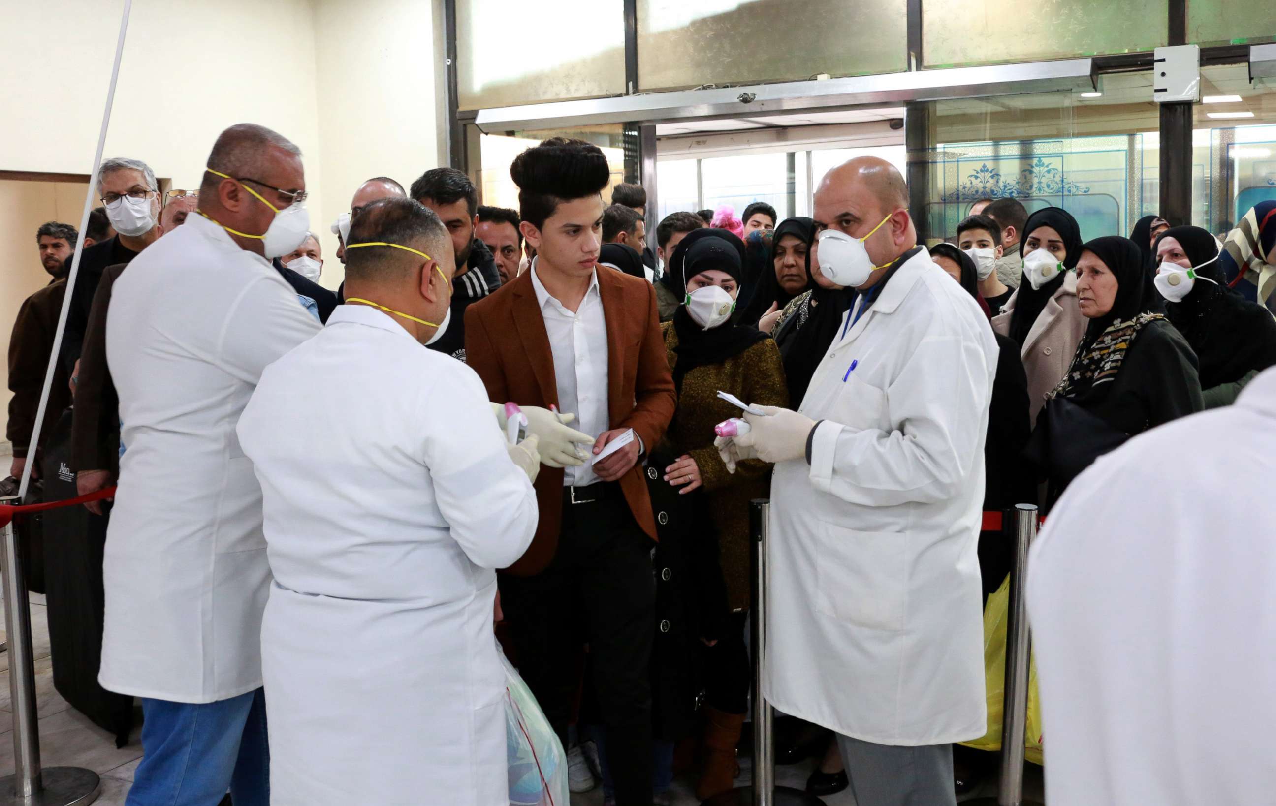 PHOTO: Members of Iraqi medical team check passengers upon arrival from Iran at Baghdad international airport in Baghdad, Iraq, Feb. 24, 2020.