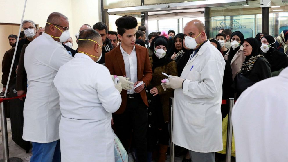 PHOTO: Members of Iraqi medical team check passengers upon arrival from Iran at Baghdad international airport in Baghdad, Iraq, Feb. 24, 2020.