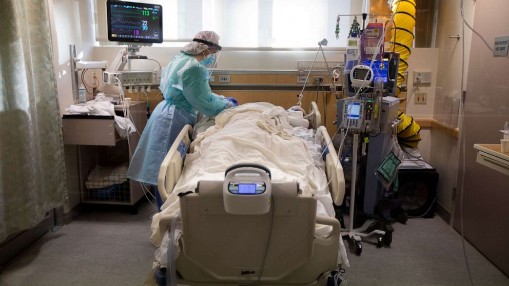 PHOTO: Registered Nurse Joan Pung, works in a COVID-19 patient's room inside the ICU at Providence St. Jude Medical Center on Dec. 25, 2020, in Fullerton, Calif.
