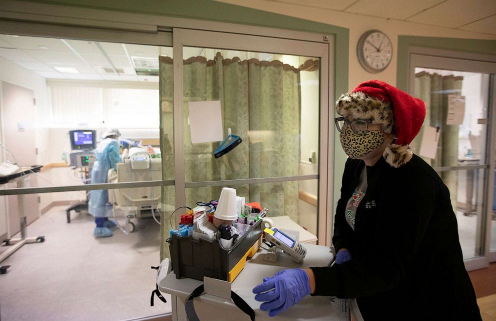 PHOTO: Brenda Lorenzo wears a Santa hat and a leopard mask over her N95 as she works inside the ICU at Providence St. Jude Medical Center Christmas Day on Dec. 25, 2020, in Fullerton, Calif.