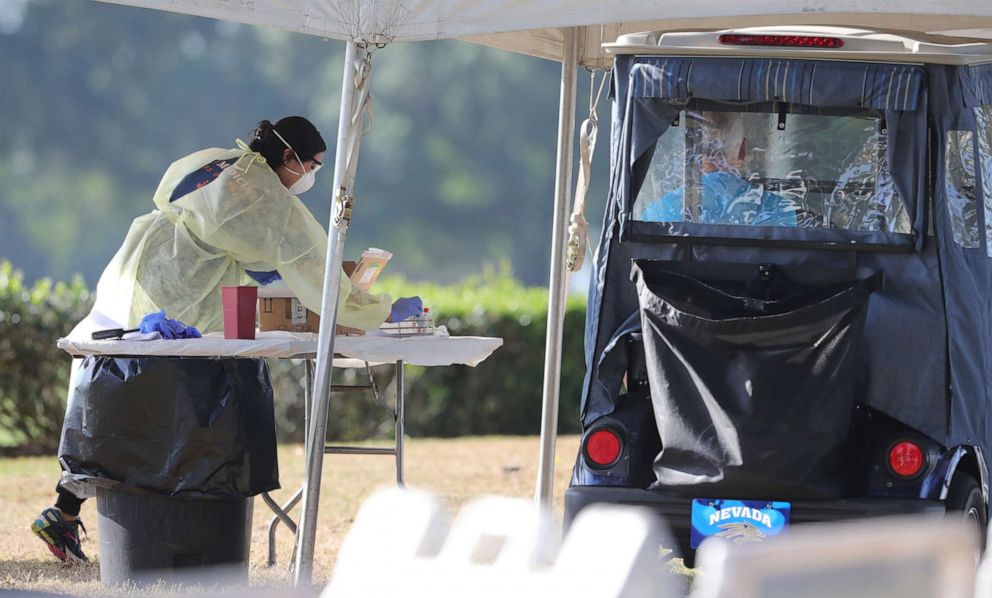 PHOTO: A University of Florida medical student prepares to test a resident of The Villages, Fla. at a drive-through site at The Villages Polo Club, Monday, March 23, 2020.