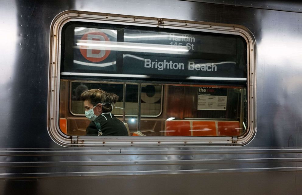 PHOTO: A commuter rides a subway car as it passes though a New York City subway station as the city feels the impact of the coronavirus, March 19, 2020.