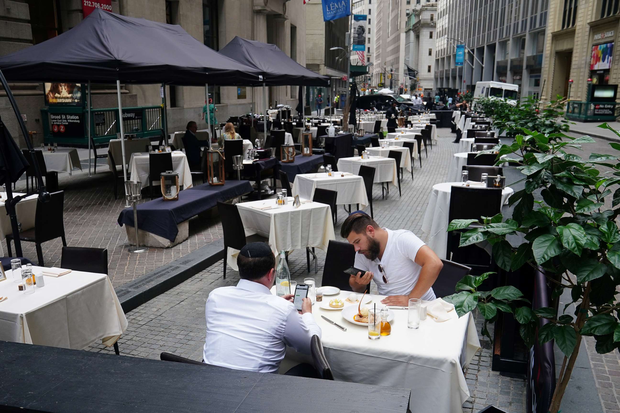 PHOTO: People eat at a mostly empty restaurant with tables on the street, in the financial district during the coronavirus pandemic in New York, Sept. 9, 2020. 