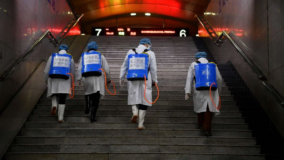 PHOTO: Workers with sanitizing equipment walk up a flight of stairs as they disinfect a railway station during the coronavirus outbreak, in Kunming, Yunnan province, China, Feb. 4, 2020.