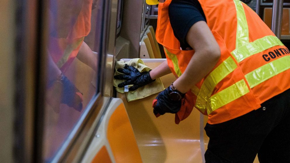 PHOTO:A contractor for the Metropolitan Transit Authority (MTA) wipes a bench of a subway train in New York, June 10, 2020.