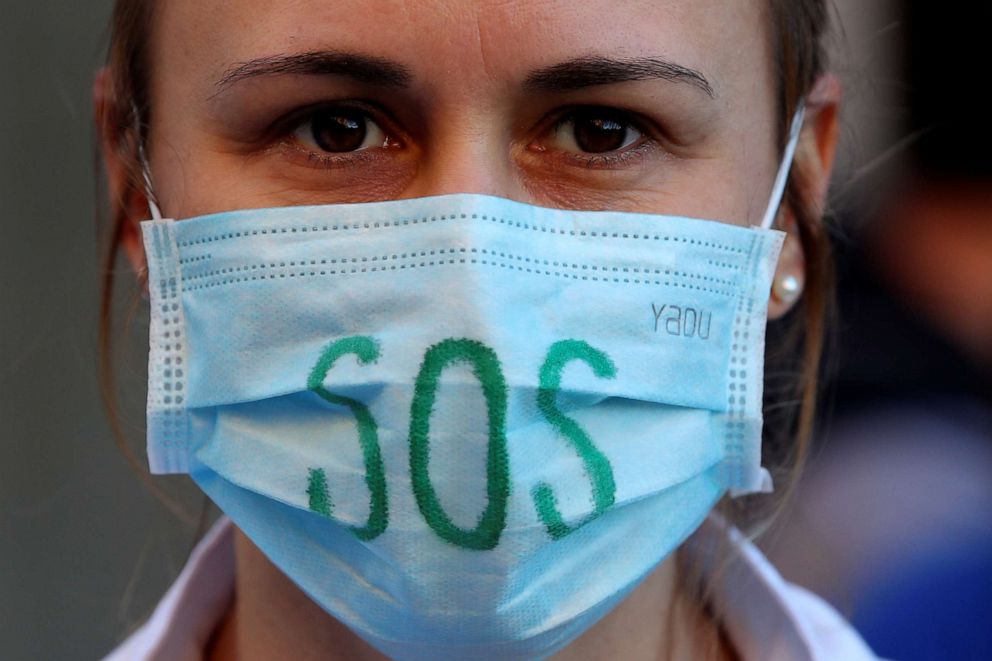 PHOTO: A health worker wearing a protective face mask attends a protest to urge the government to increase staff as hospitals, at the CHIREC Braine l'Alleud-Waterloo hospital in Braine l'Alleud, Belgium, Nov. 5, 2020.