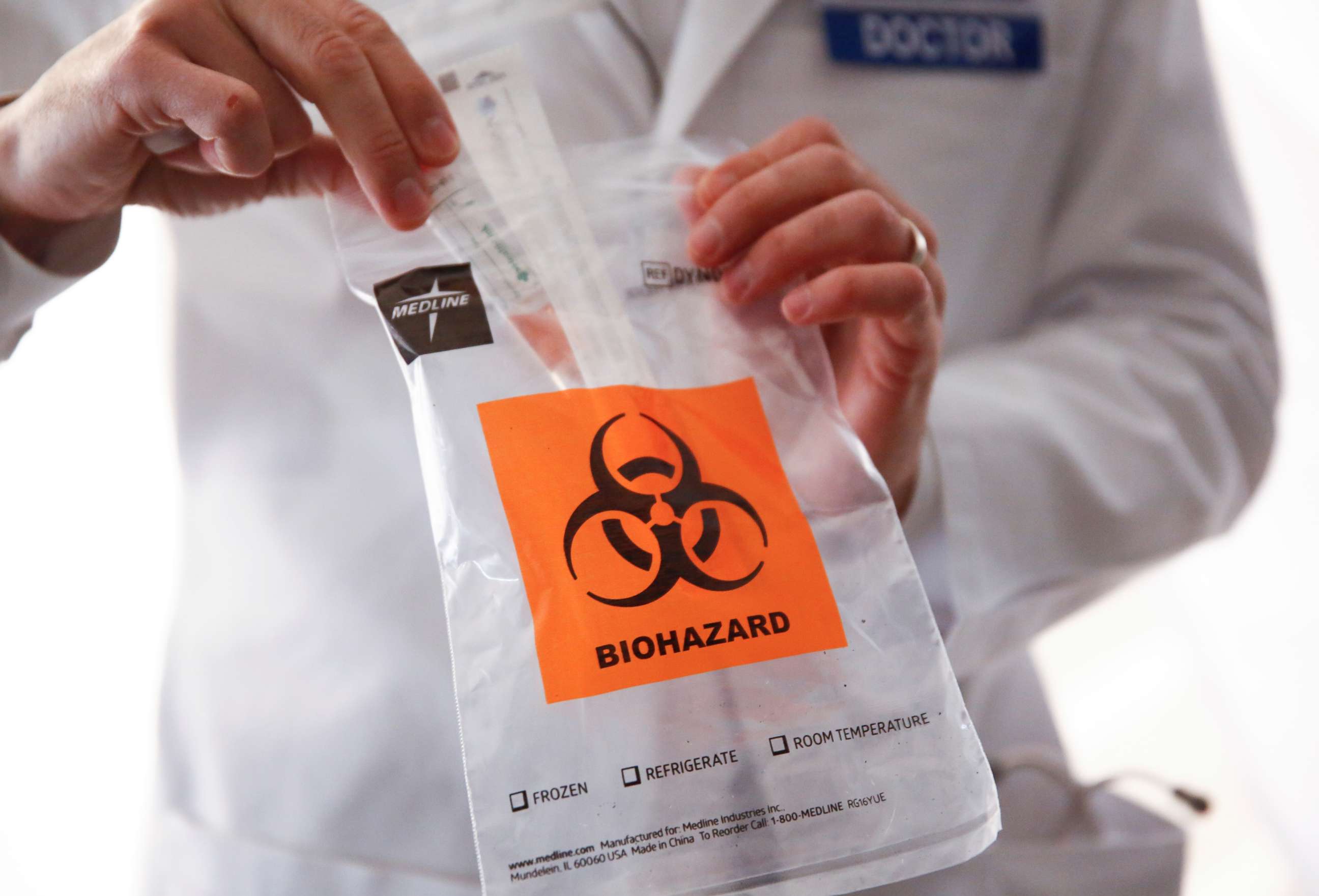 PHOTO: Medical director of infection prevention and employee health Dr. Seth Cohen shows a sample test kit at a drive-through clinic for coronavirus, flu and RSV, in Seattle, on March 9, 2020.