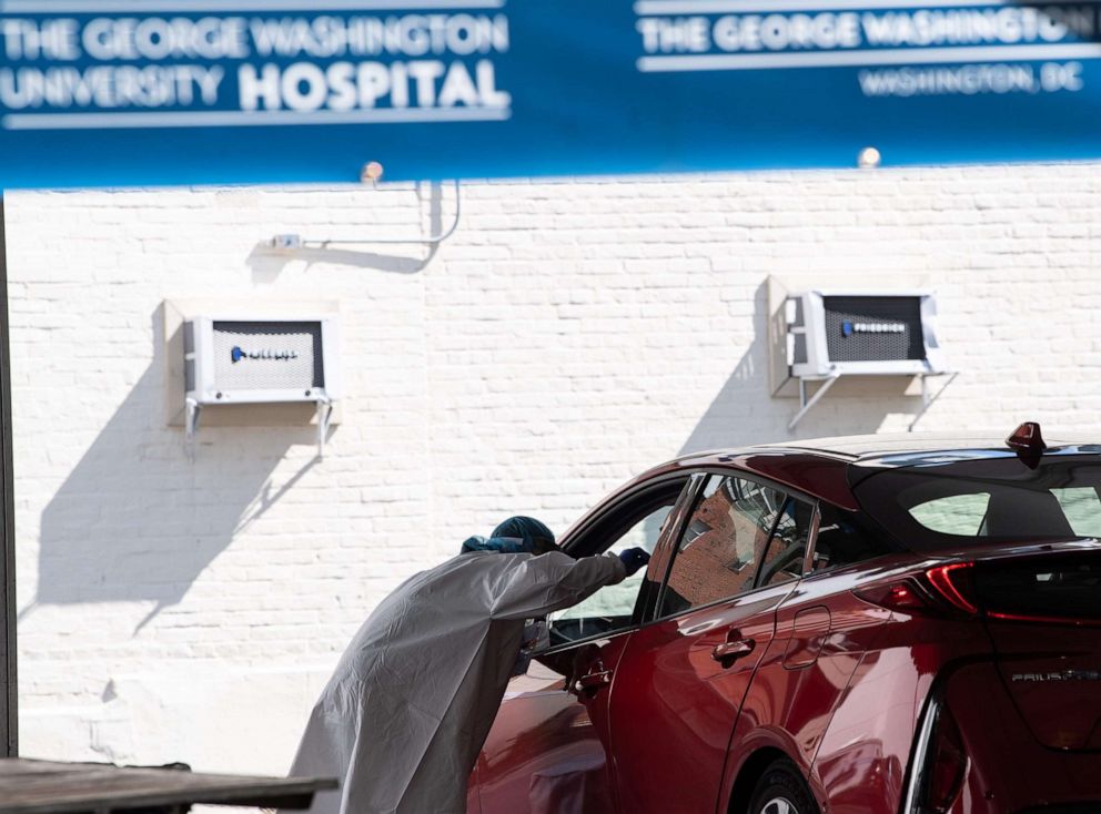 PHOTO: A nurse administers a COVID-19 test at a drive-through testing center at George Washington University in Washington, D.C., May 7, 2020.