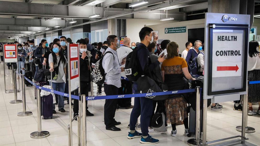 PHOTO: Passengers line up to have their health assessed at a checkpoint for people flying in from a list of countries and territories as a precautionary measure against the spread of coronavirus at Suvarnabhumi Airport in Bangkok on March 9, 2020. 