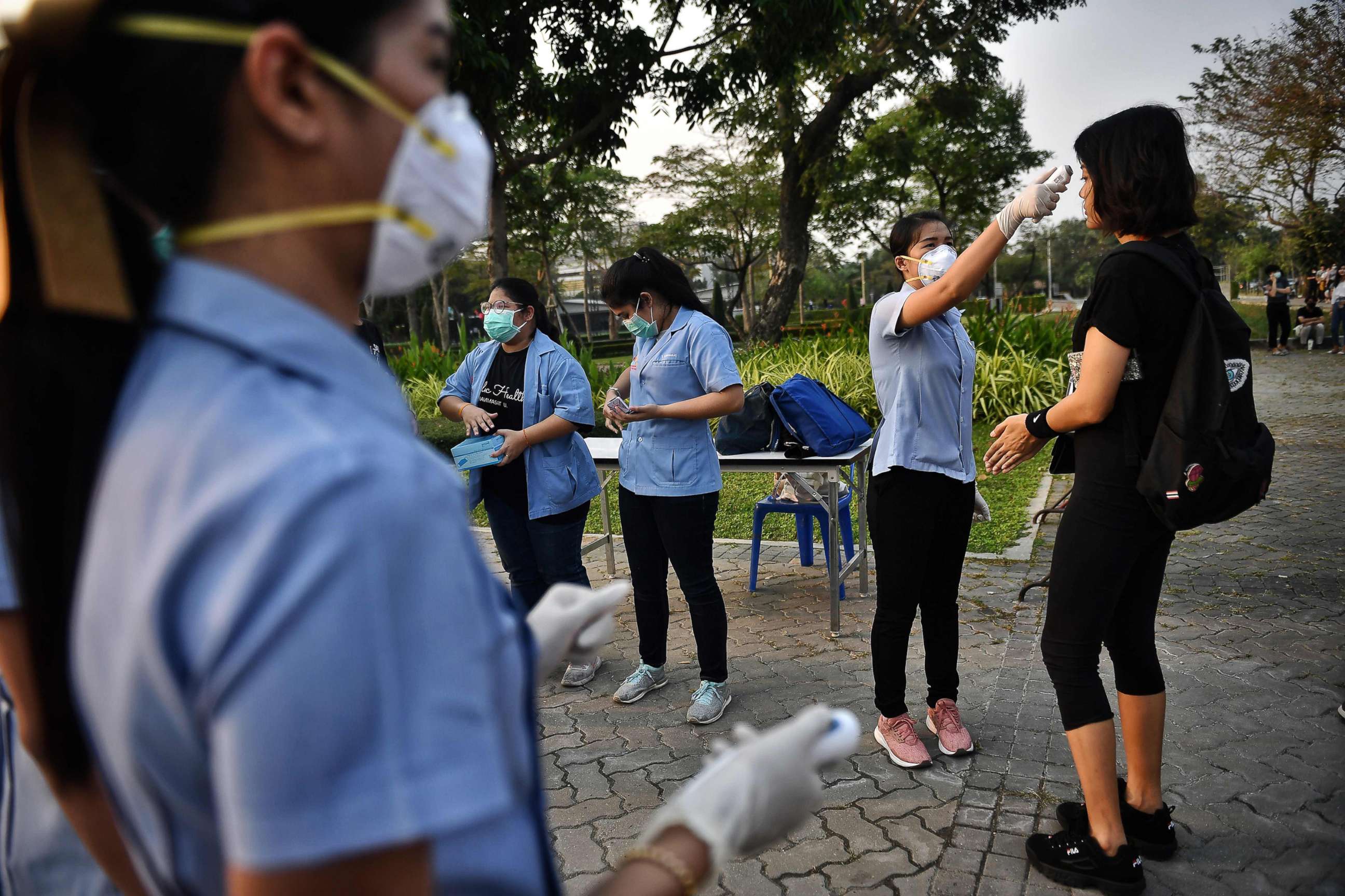 PHOTO: Students get their temperature tested for signs of the COVID-19 coronavirus at a pro-democracy rally against the military government at Thammasat University in Bangkok, Feb. 26, 2020.