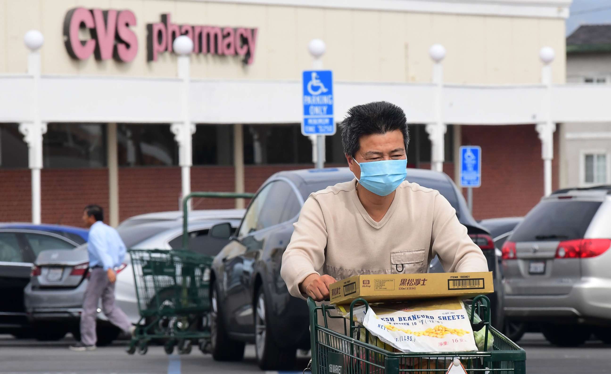 PHOTO: A man wears a facemask while pushing his shopping cart in Alhambra, Calif., Feb. 27, 2020.