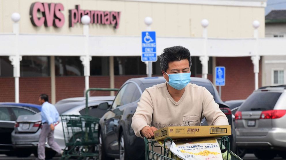 PHOTO: A man wears a facemask while pushing his shopping cart in Alhambra, Calif., Feb. 27, 2020.