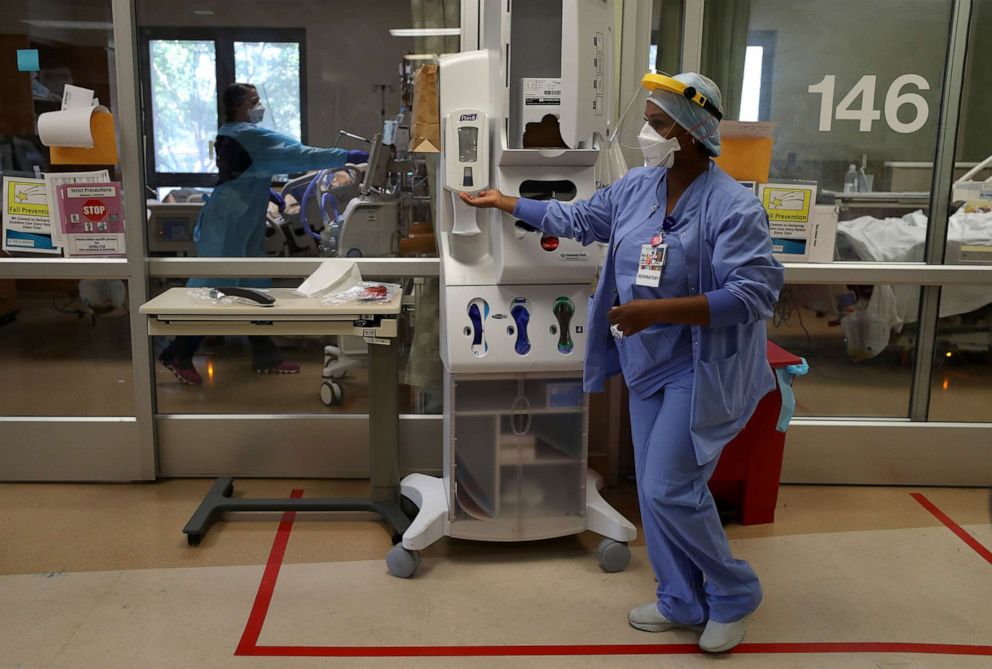 PHOTO: A nurse uses hand sanitizer before entering the room of a coronavirus patient in the intensive care unit at Regional Medical Center on May 21, 2020, in San Jose, Calif.