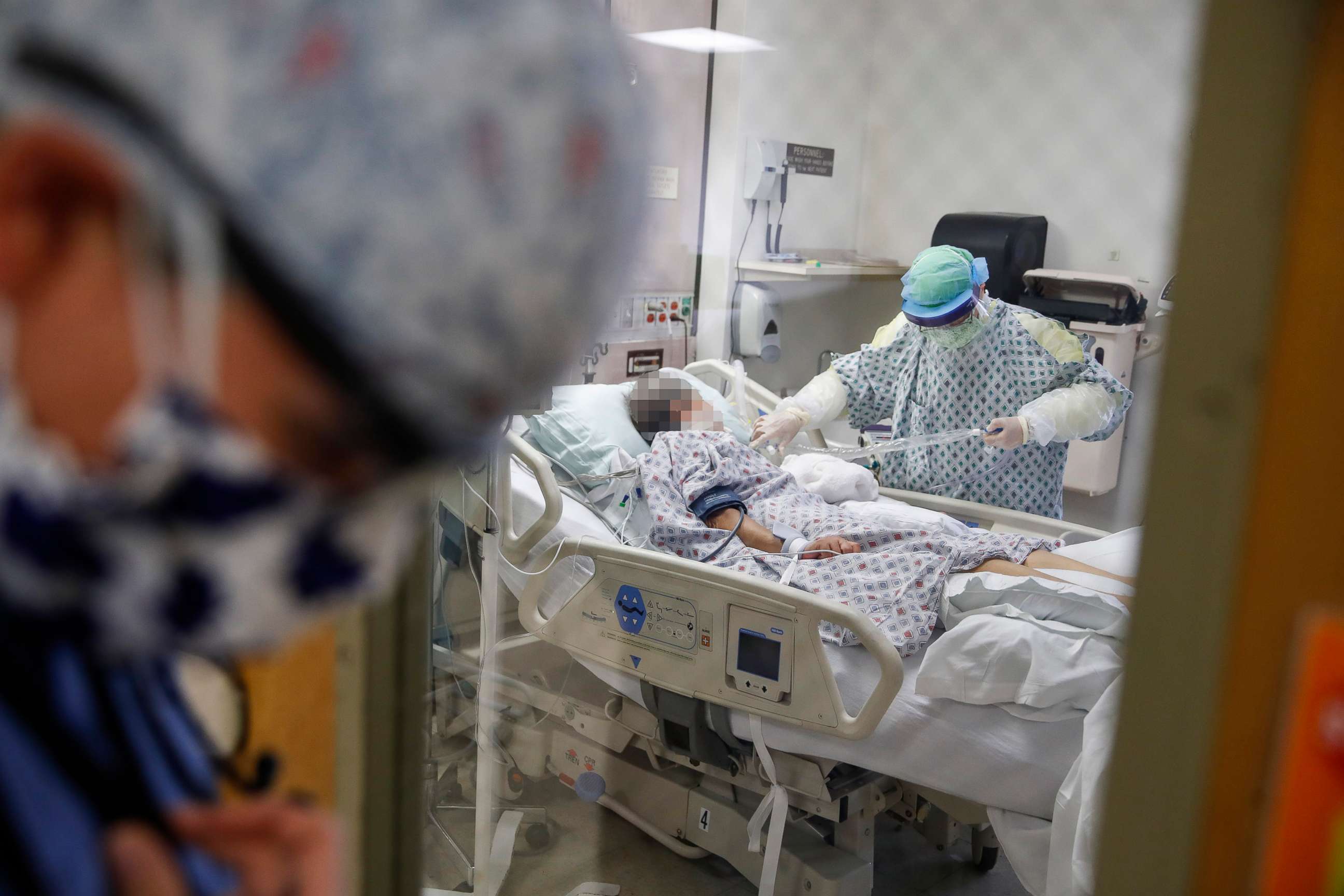 PHOTO: Resident physician Leslie Bottrell stands outside a room at an Intensive Care Unit as a nurse suctions the lungs of a COVID-19 patient at St. Joseph's Hospital in Yonkers, N.Y., April 20, 2020.