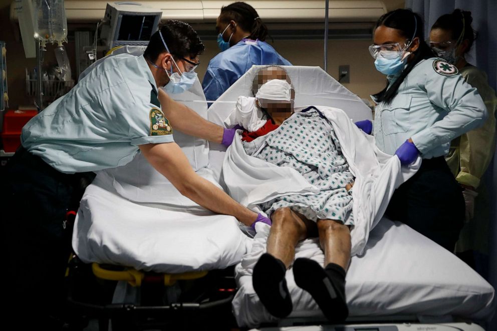 PHOTO: Emergency medical technicians transport a patient from a nursing home to an emergency room bed at St. Joseph's Hospital in Yonkers, N.Y., April 20, 2020.