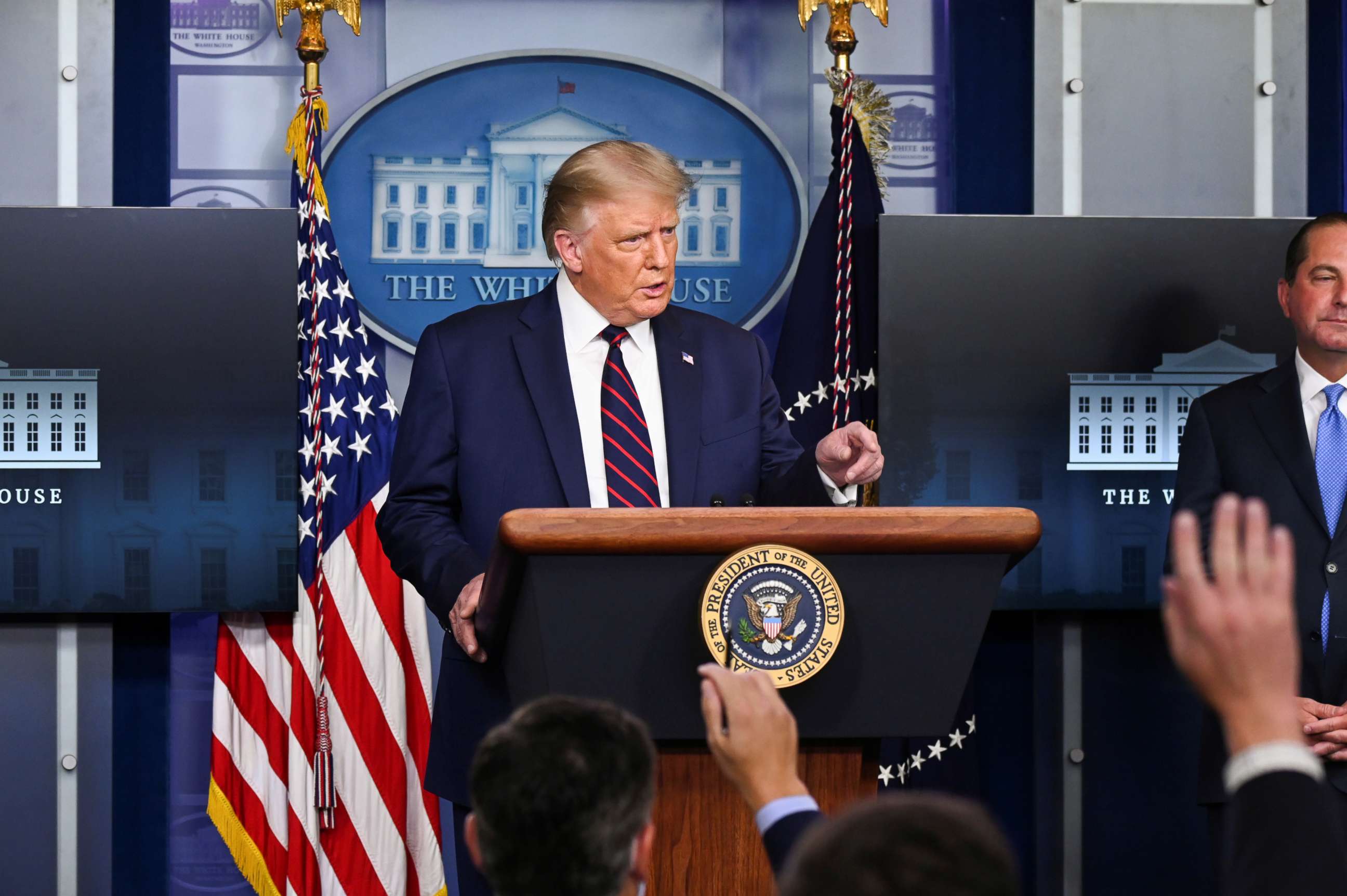 PHOTO: U.S. President Donald Trump gestures towards media members, who raise their hands to ask questions, during a news conference about the latest coronavirus disease (COVID-19) developments, August 23, 2020. 