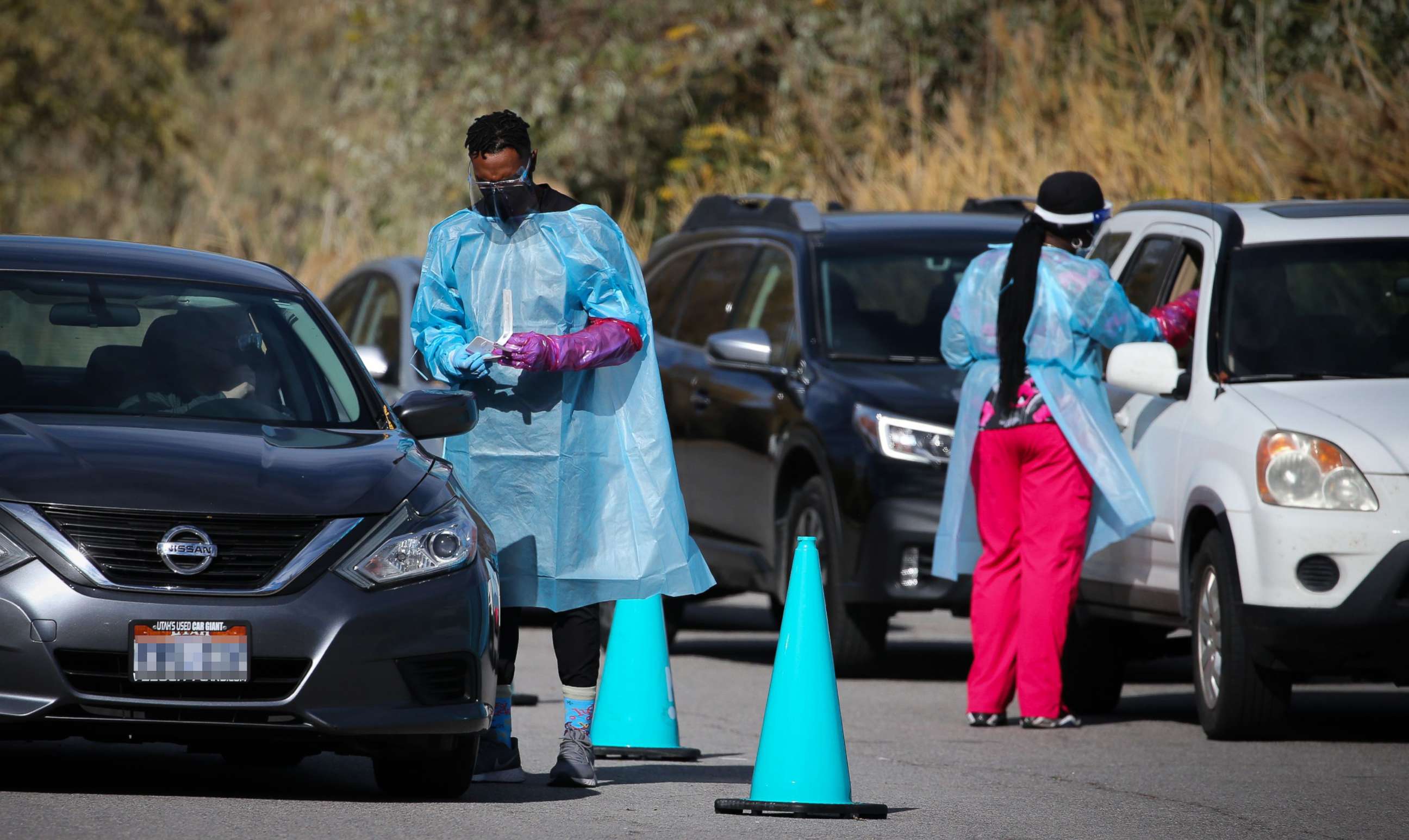 PHOTO: Medical workers talk to people in cars at a Nomi Health COVID-19 mobile testing site in Holladay, Utah, Nov. 4, 2021.