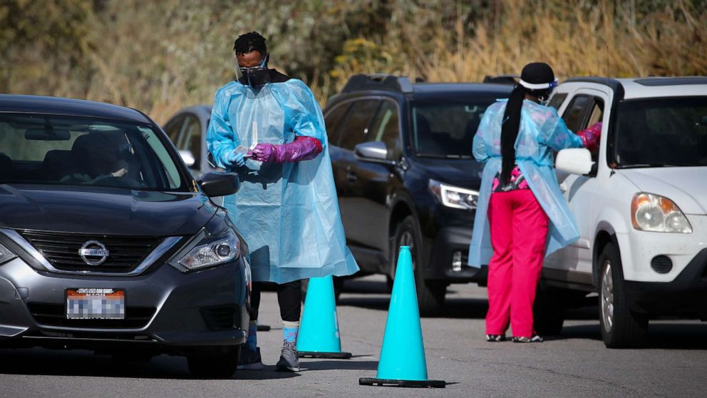 PHOTO: Medical workers talk to people in cars at a Nomi Health COVID-19 mobile testing site in Holladay, Utah, Nov. 4, 2021.