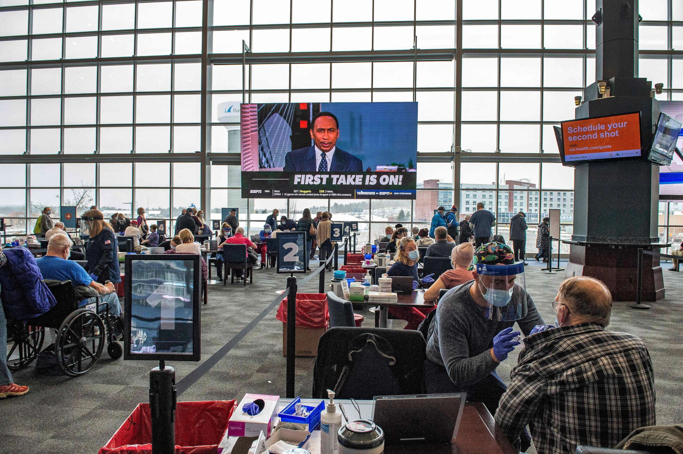 PHOTO: Medical workers provide vaccines against COVID-19 at Gillette Stadium in Foxborough, Mass., Feb. 1, 2021.