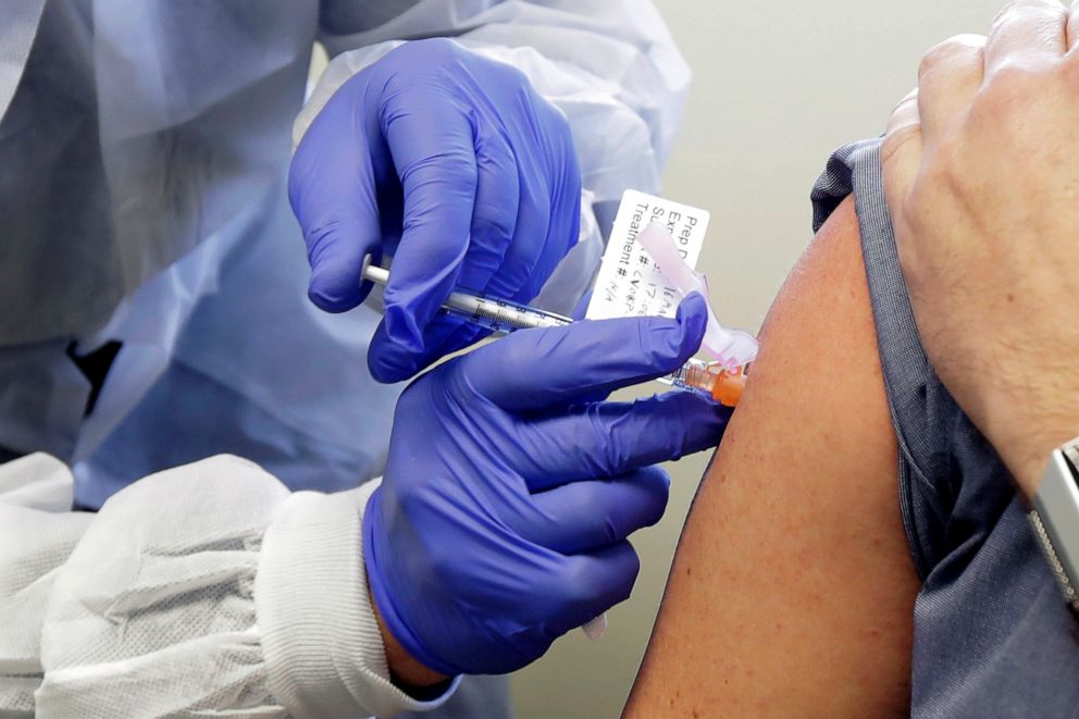 PHOTO: A subject receives a shot in the first-stage safety study clinical trial of a potential vaccine by Moderna for COVID-19, the disease caused by the new coronavirus, at the Kaiser Permanente Washington Health Research Institute in Seattle, FILE.