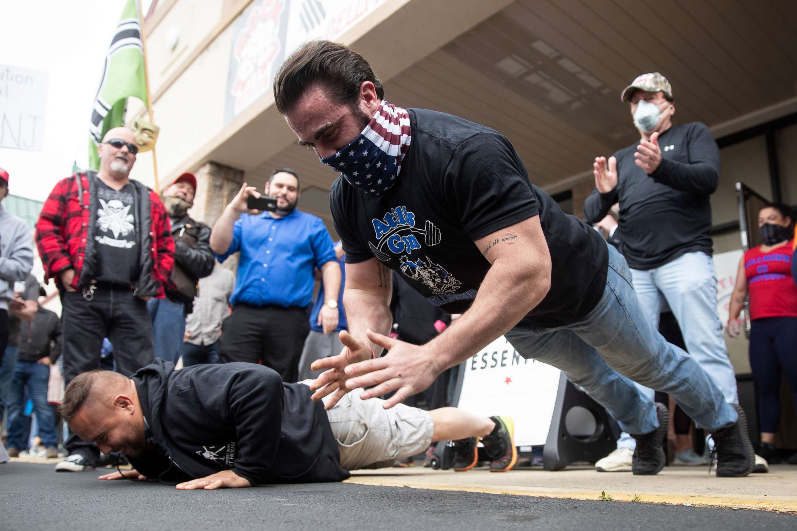 PHOTO: Atilis Gym co-owner Ian Smith does pushups outside the storefront in Bellmawr, N.J., May 18, 2020.