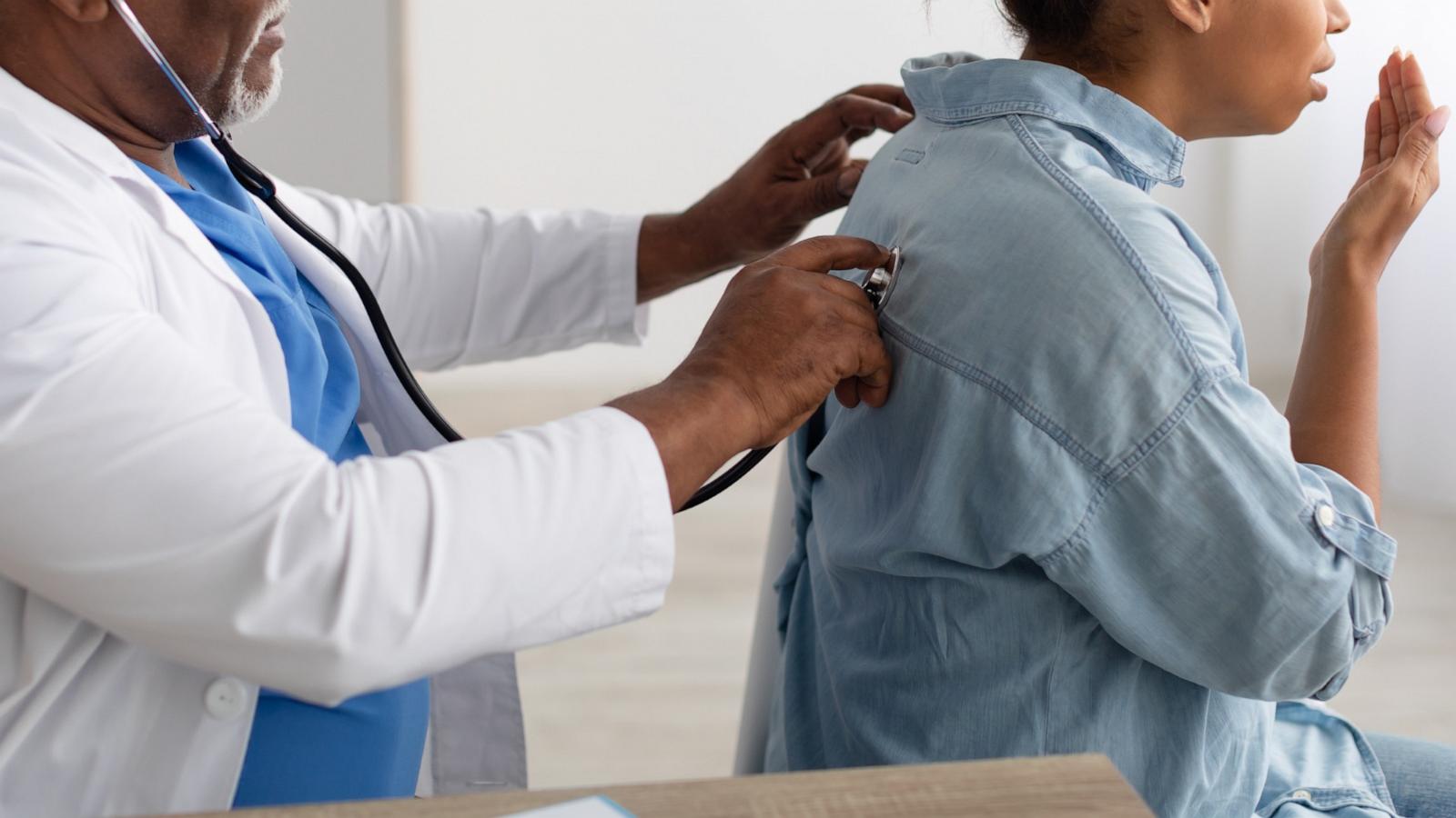 PHOTO: A general practitioner examines a coughing patient in this undated stock photo.