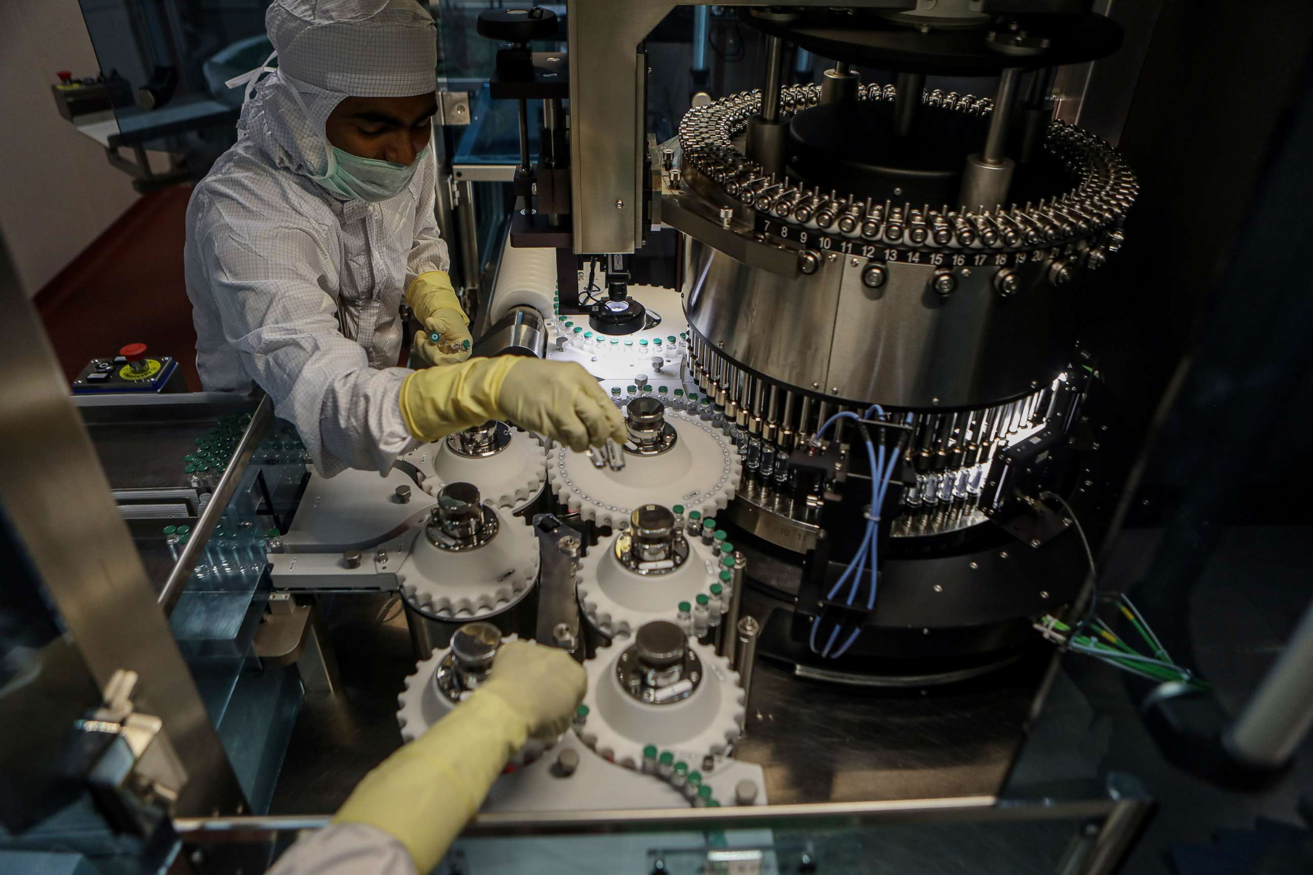 PHOTO: Employees work on the production line of a COVID-19 vaccine manufacturer for the COVAX facility in Pune, a city located in the western Indian state of Maharashtra, Feb. 24, 2021.