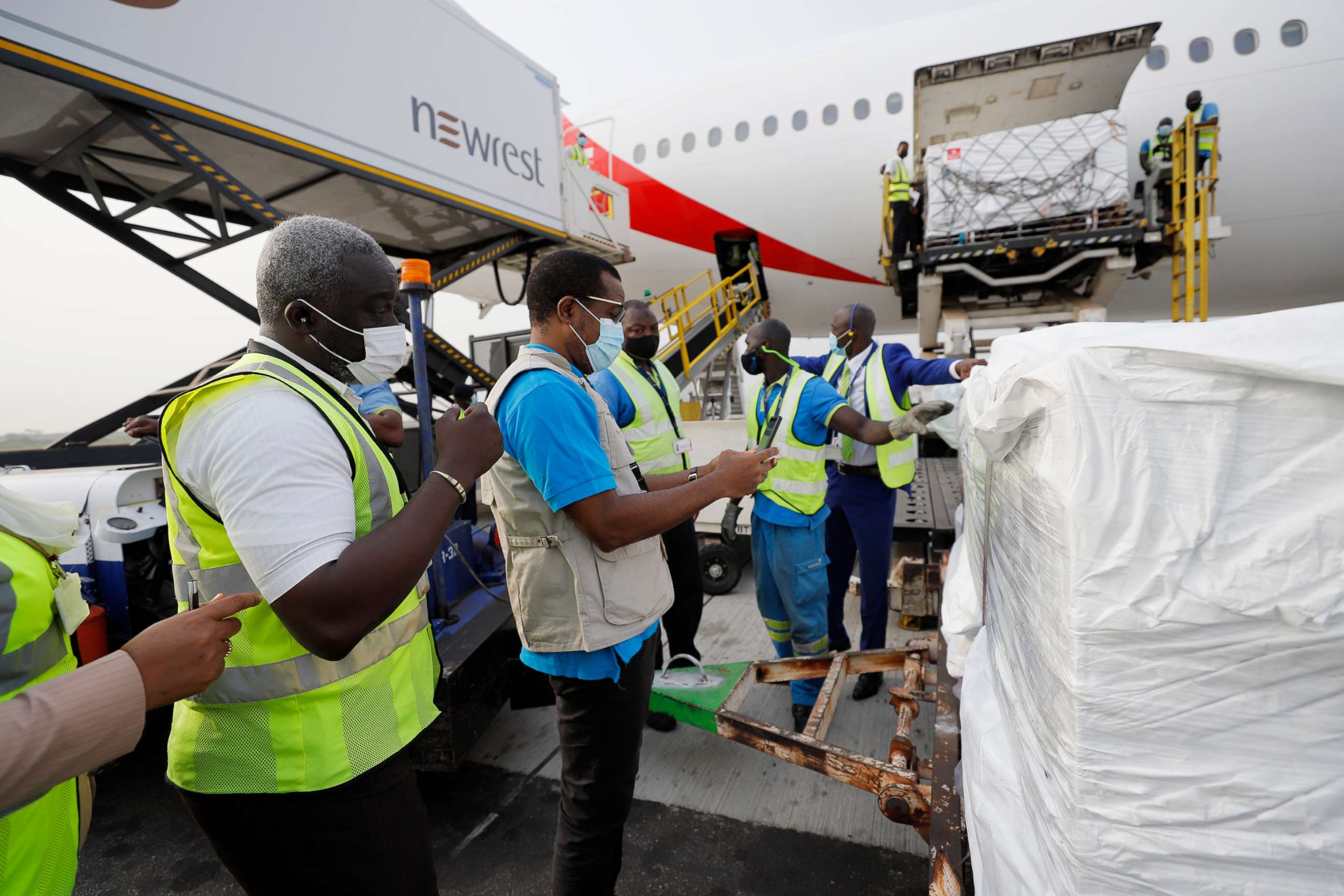 PHOTO: Staffers unload the first shipment of COVID-19 vaccines distributed by the COVAX facility at the Kotoka International Airport in Accra, the capital of Ghana, Feb. 24, 2021.