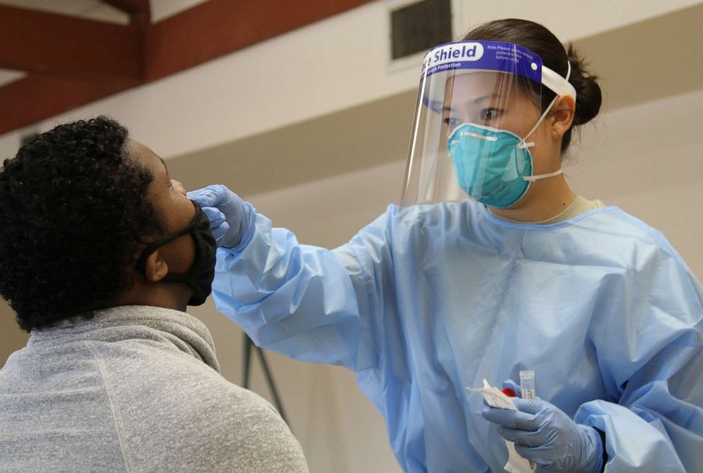 PHOTO: U.S. Air Force medic Sgt. Michiko Imai of the California Air National Guard administers a COVID-19 test to a Northern California resident at Robertson Community Center July 15, 2020 in Sacramento, California.