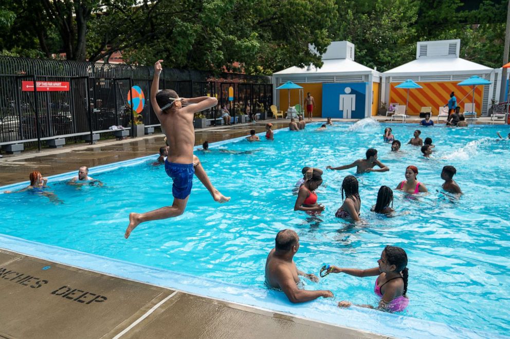 PHOTO: People enjoy the pool at Mullaly Park on the second day of opening following the phase four guideline in response to the Covid-19 pandemic on July 25, 2020, in the Bronx borough of New York City.