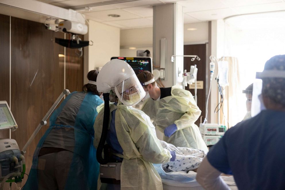 PHOTO: A team of nurses and physicians transfers a patient with COVID-19 into ICU room from the emergency room at CentraCare St. Cloud Hospital in St. Cloud, Minn., Nov. 23, 2021. 

