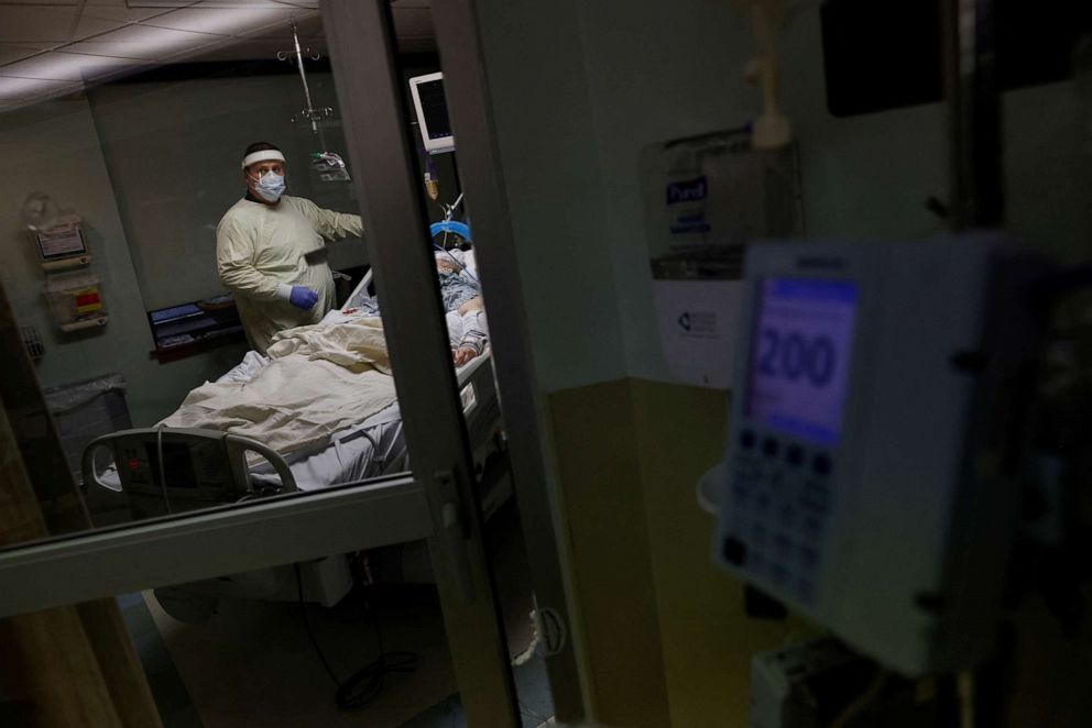 PHOTO: Medical staff treat a coronavirus disease (COVID-19) patient in their isolation room on the Intensive Care Unit (ICU) at Western Reserve Hospital in Cuyahoga Falls, Ohio, Jan. 5, 2022.