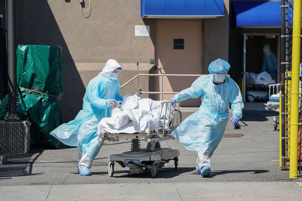 PHOTO: Bodies are moved to a refrigeration truck serving as a temporary morgue at Wyckoff Hospital in the Borough of Brooklyn, April 6, 2020, in New York.