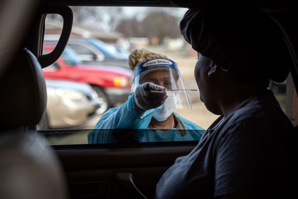 PHOTO: A healthcare worker administers a COVID-19 swab test during a mobile clinic at Saint Paul MB Church in Cleveland, Miss., Jan. 8, 2022. 
