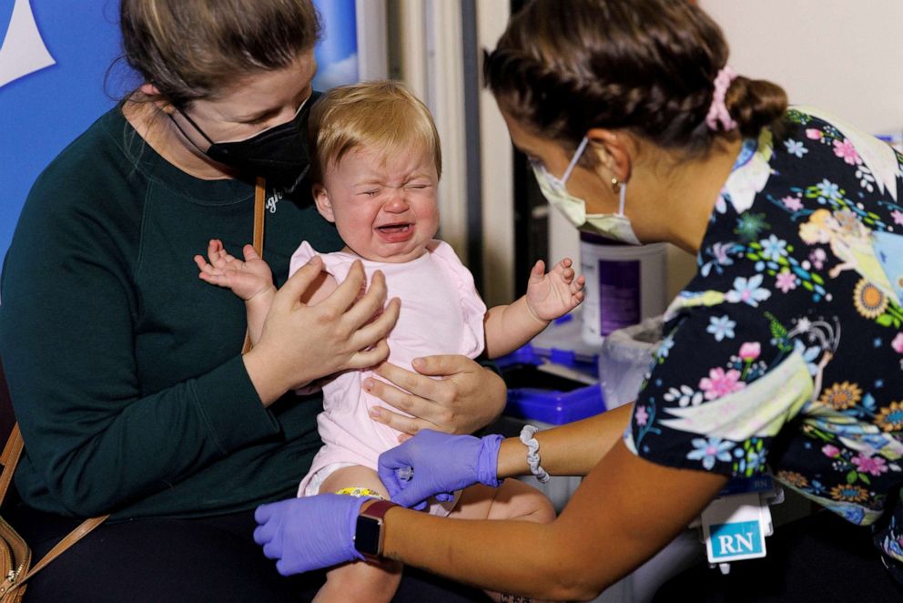 PHOTO: Following CDC approval for vaccination of children aged 6 months to 5 years, 10-month-old Hazel Ribnik reacts, as nurse Jillian Mercer administers the vaccine for COVID-19 at Rady Children's Hospital in San Diego, June 21, 2022.