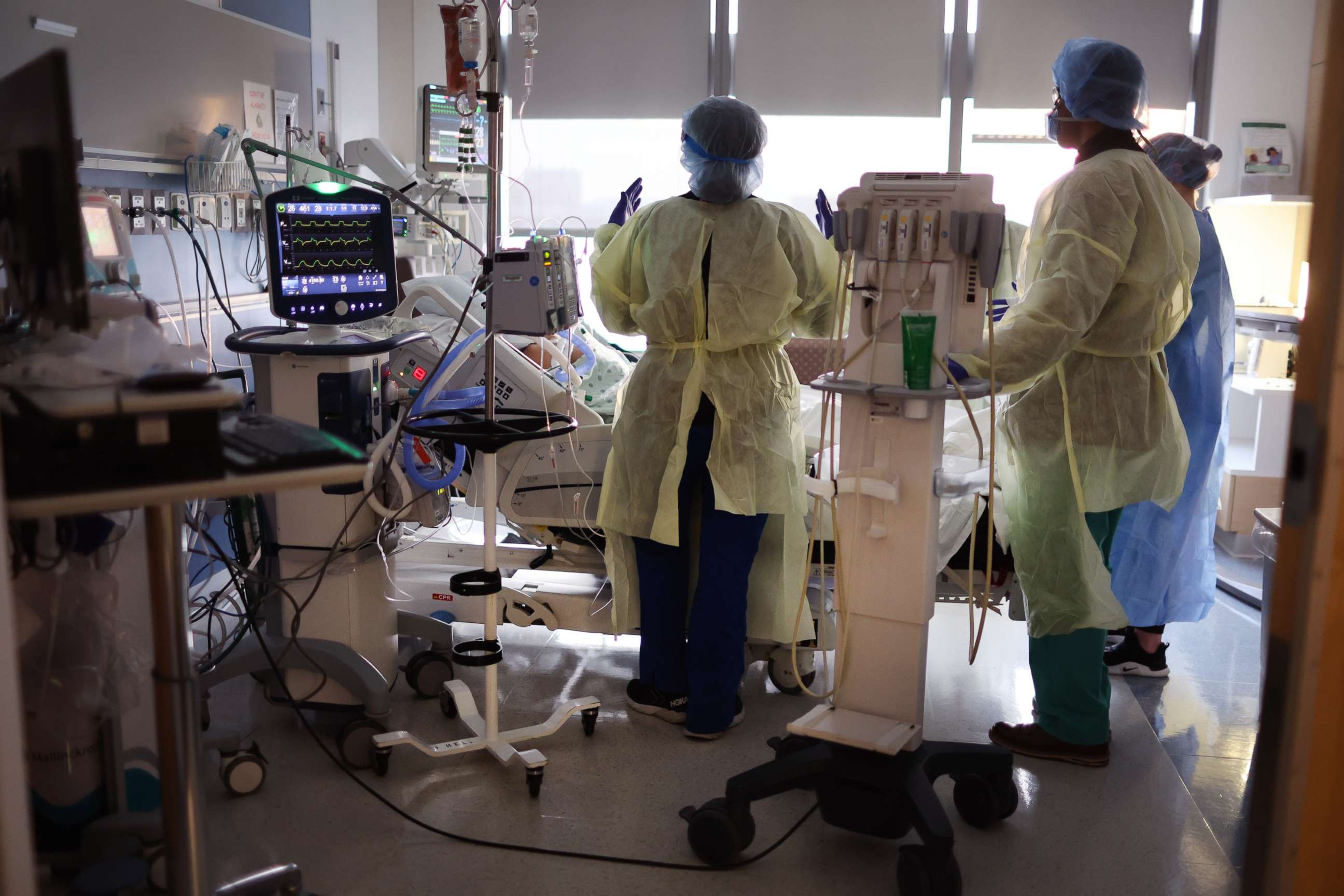 PHOTO: Respiratory Therapist Annette Johnson helps to treat a COVID-19 patient in the ICU at Rush University Medial Center, Jan. 31, 2022, in Chicago.