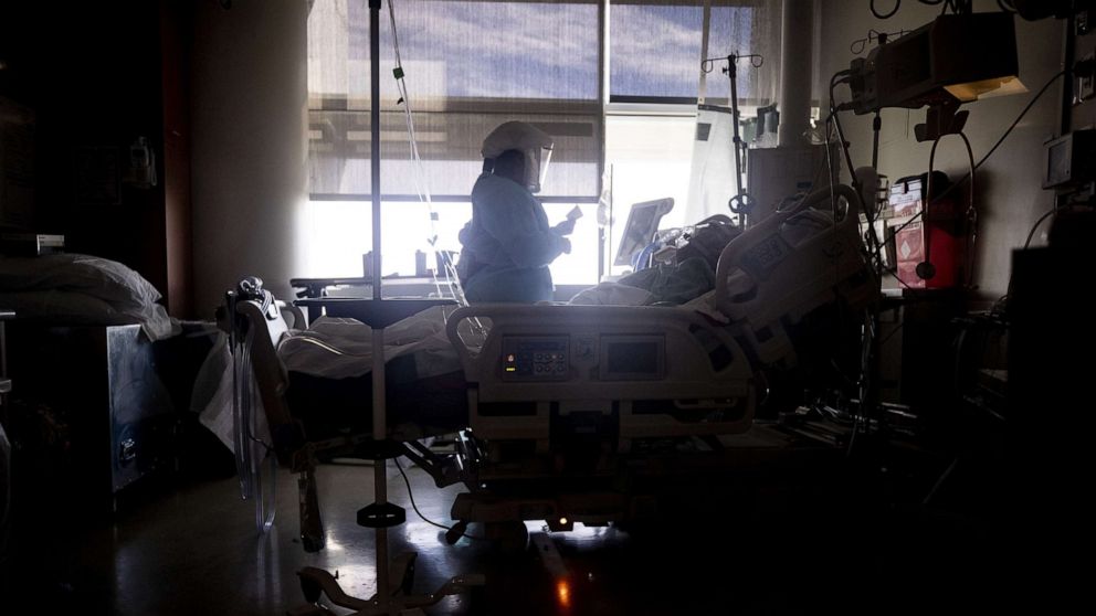 PHOTO: A nurse treats a COVID-19 patient in the ICU of the Sharp Grossmont Hospital in La Mesa, Calif., Jan. 11, 2022.