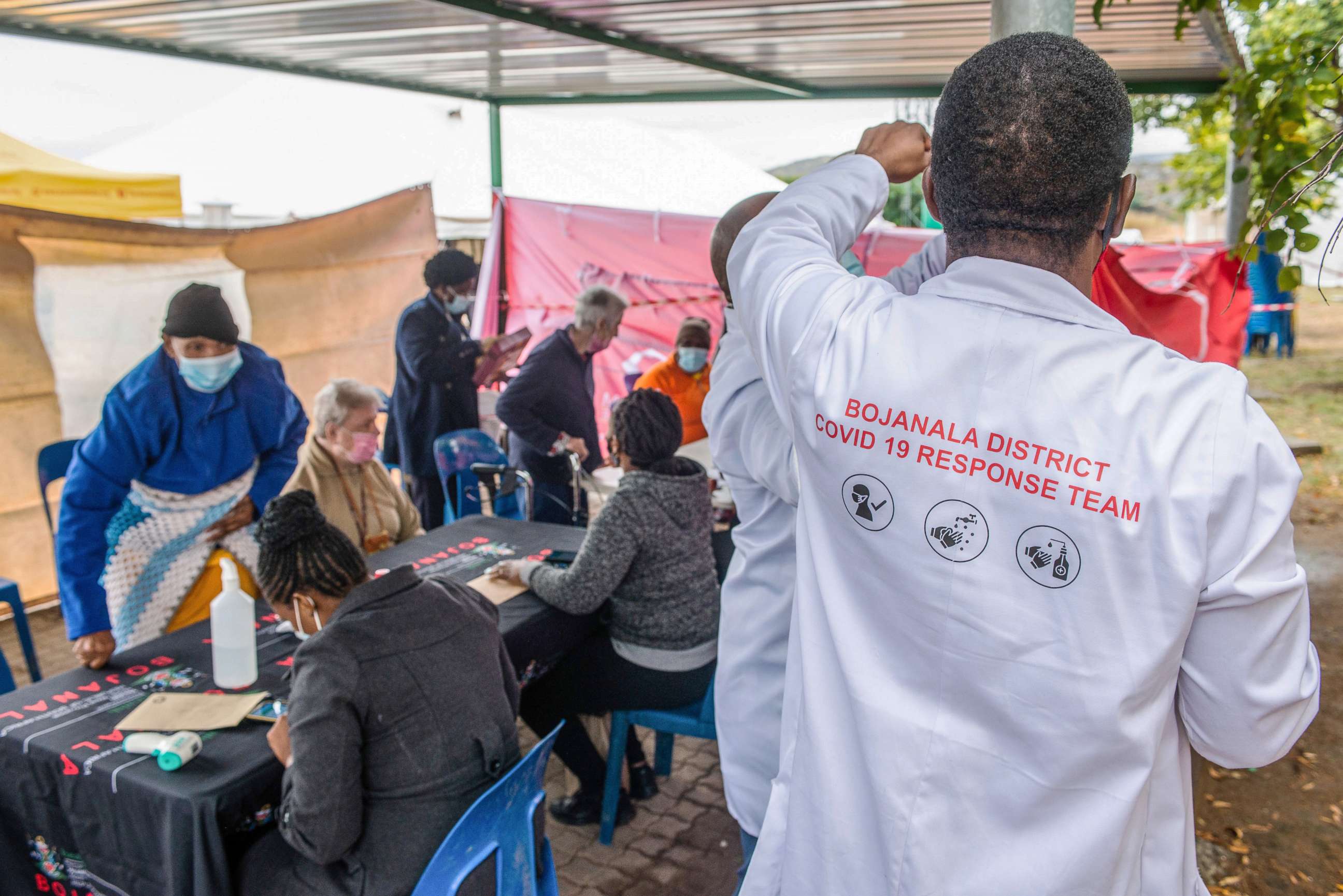 PHOTO: A health worker directs elderly residents arriving to register for the Covid-19 vaccination program outside the Bonang Community Health Centre, in Brits, South Africa,  April 30, 2021