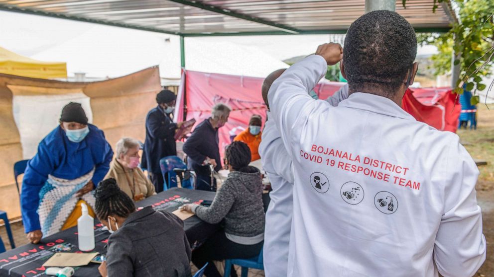 PHOTO: A health worker directs elderly residents arriving to register for the Covid-19 vaccination program outside the Bonang Community Health Centre, in Brits, South Africa,  April 30, 2021