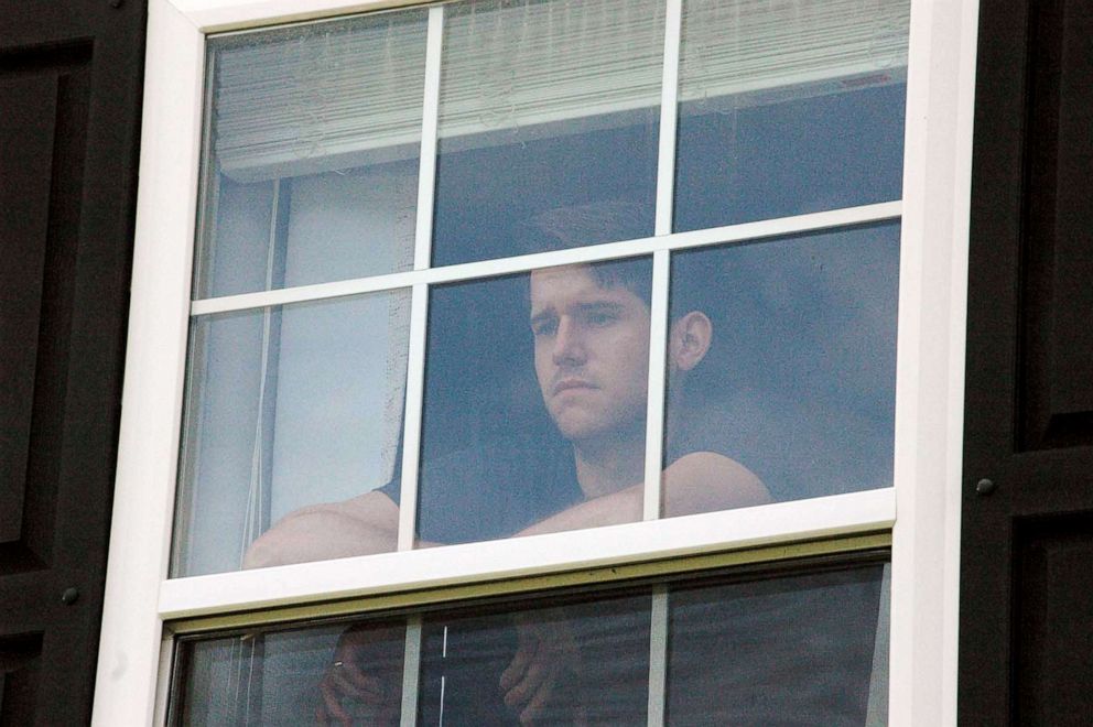 PHOTO: Von Lewis gazes out the window of a spare upstairs room he has called home during isolation with Covid-19 in New Bern N.C., Aug. 27, 2021.