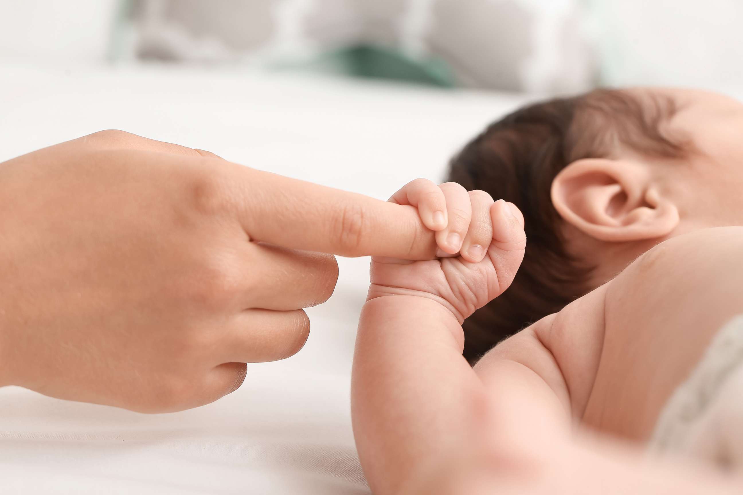 PHOTO: A newborn baby holds a mother's hand in an undated stock image.