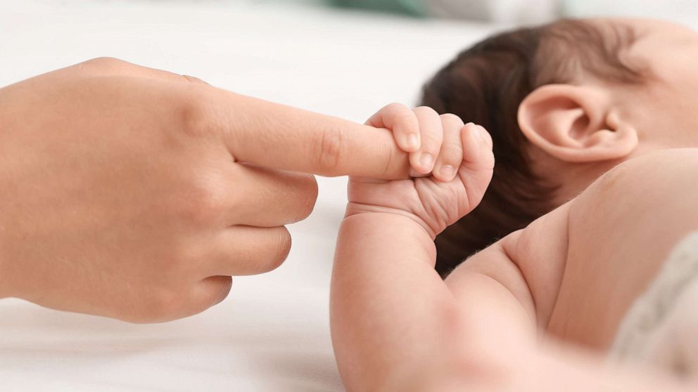 PHOTO: A newborn baby holds a mother's hand in an undated stock image.