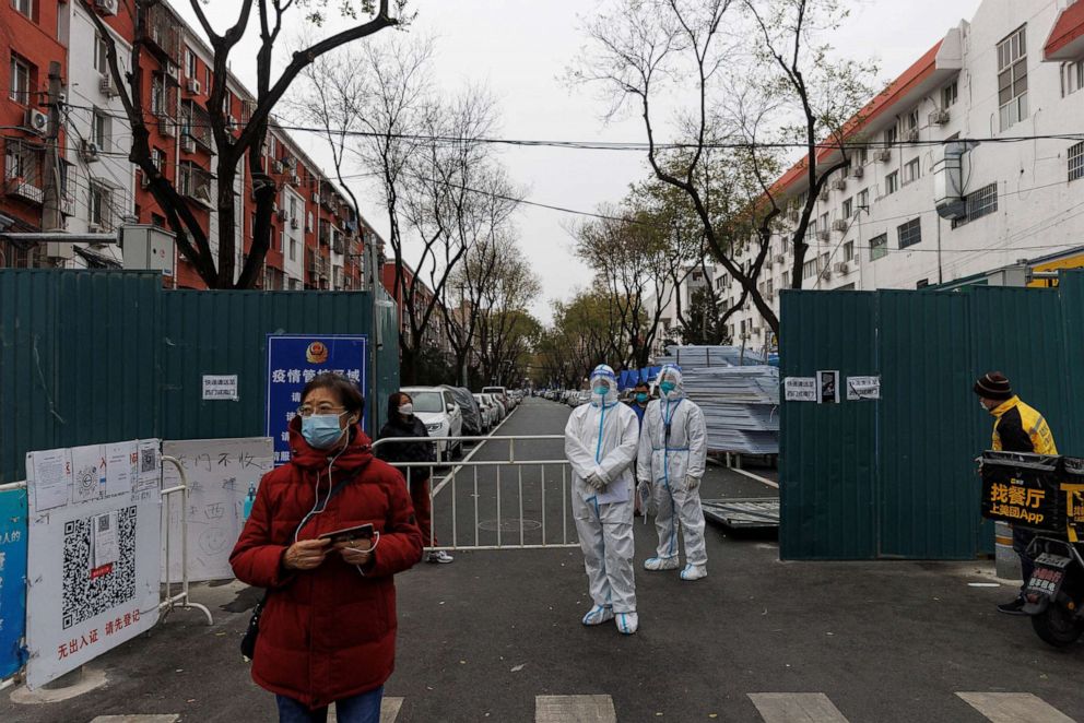 PHOTO: Epidemic-prevention workers in protective suits stand guard at a residential compound as outbreaks of coronavirus disease (COVID-19) continue in Beijinga, Nov. 28, 2022.