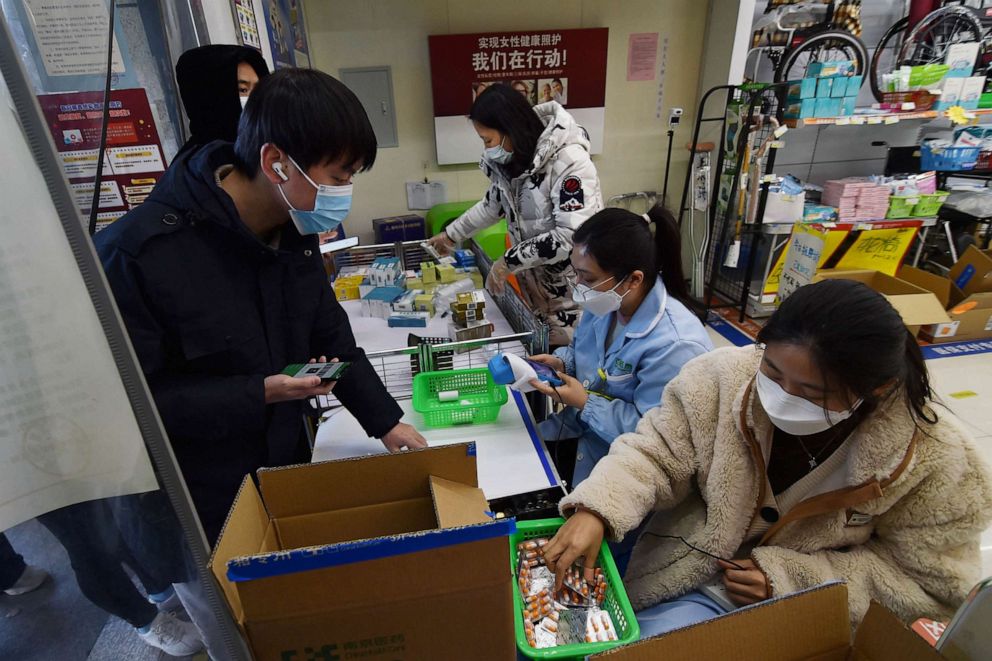 PHOTO: Customers buy medicine at a pharmacy as the local government distributes more fever medicines to the market, following the coronavirus disease (COVID-19) outbreak, in Nanjing, Jiangsu province, China, Dec. 19, 2022.