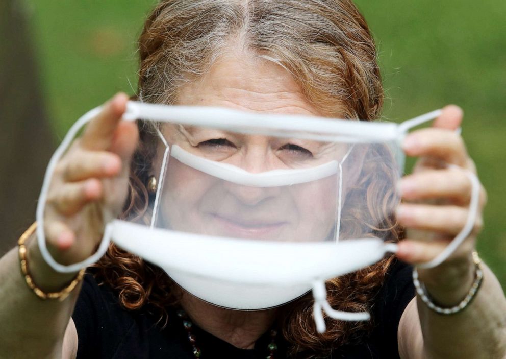 PHOTO: Arlene Romoff holds up a clear mask like the one she is wearing that helps her and others with hearing impairments read lips of doctors and other medical providers in Hackensack, N.J., July 9. 2020.